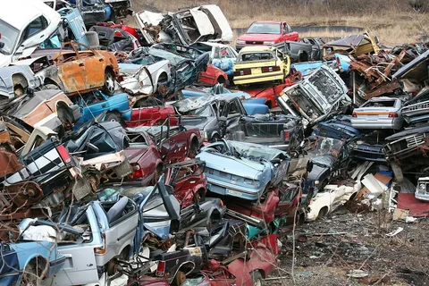 Old and scrap cars in a vehicle recycling yard in the UAE
