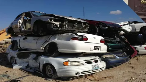 Damaged and unwanted cars in a vehicle scrap yard